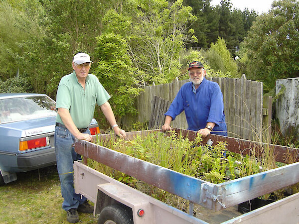 Allan and John with plants propagated by them at the Southland Community Nursery, Otatara, for a Lions Club planting working bee at Kew Bush.